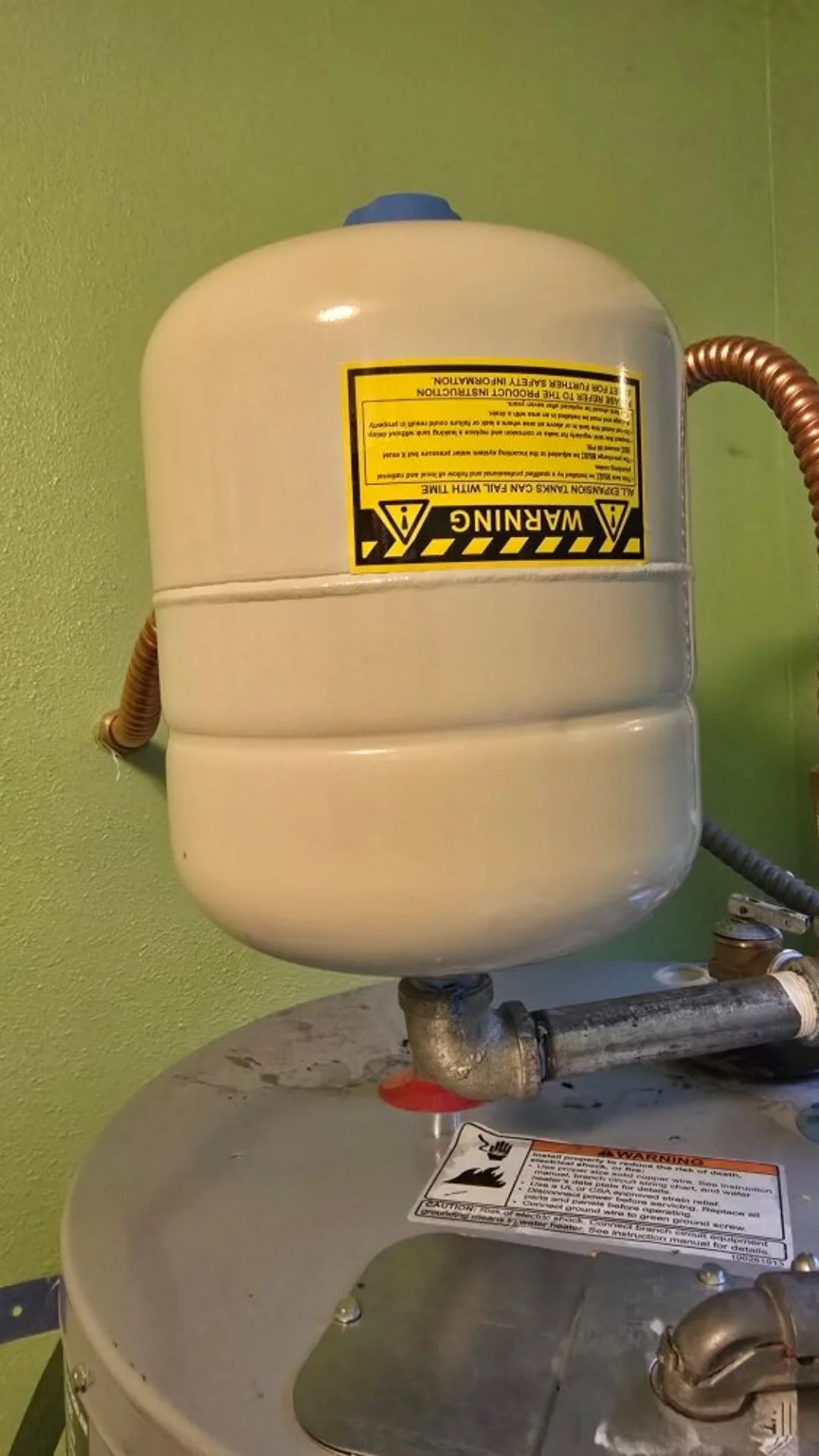 A thermal expansion tank attached with threaded fittings above a water heater in Beaverton.